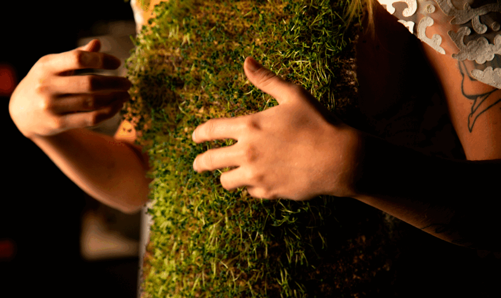 Medium shot of the torso of a woman wearing a corset with built-in plants